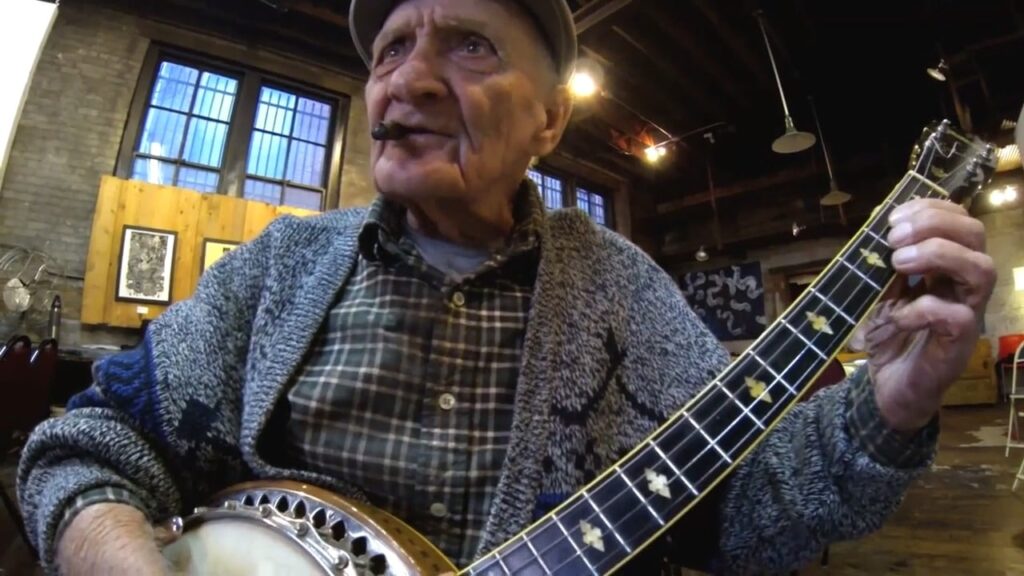 Meredith doing his favorite thing with his banjo music and a cigar.