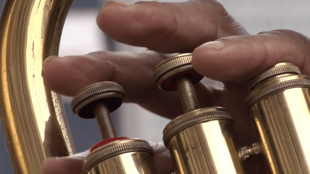 A close up of Aaron's tuba player skills, showing us why he is a everyday hero.