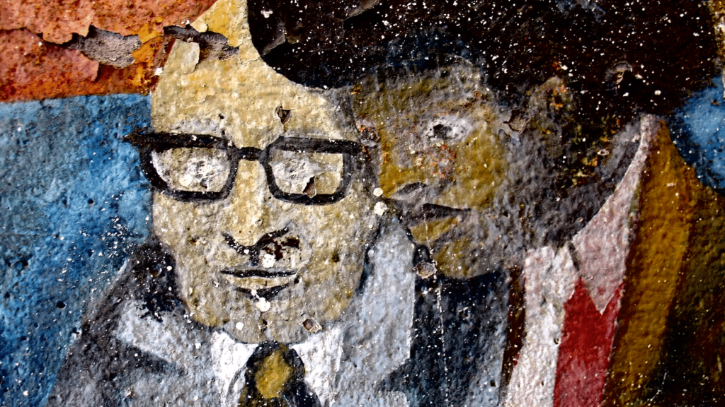Another example of Mural art painting of two men collaborating.