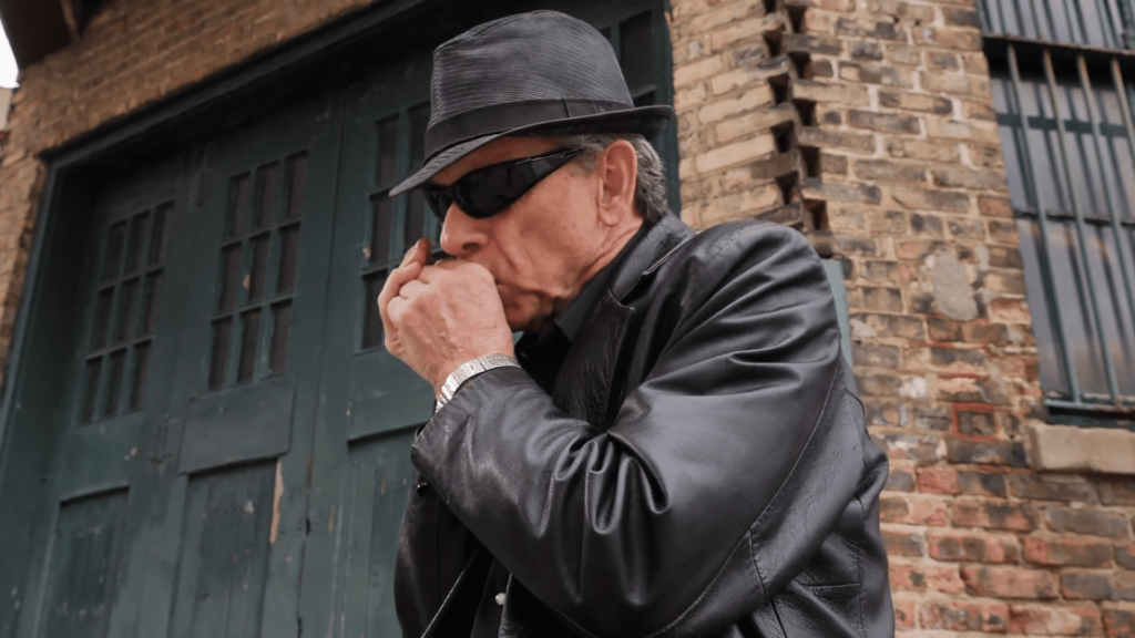 Mike playing harmonica.