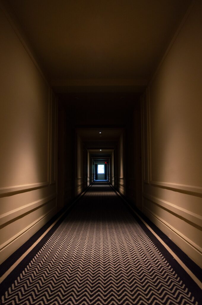 A spooky hotel corridor much like one you'd see at one of the haunted hotels listed in this article.